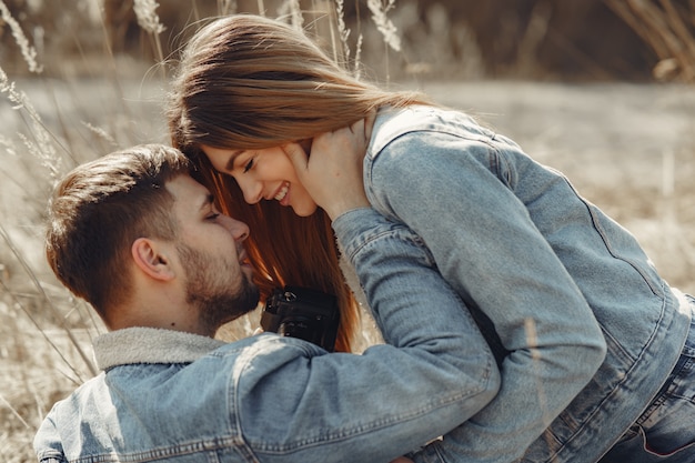 Cute couple in a jeans clothes in a spring field