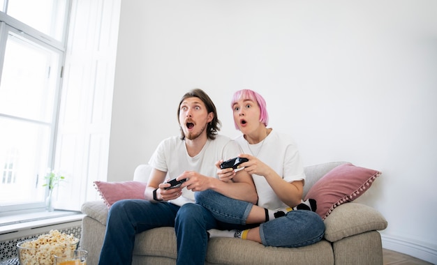 Cute couple playing videogames on the couch