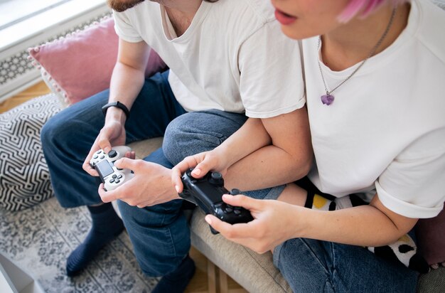 Cute couple playing videogames on the couch