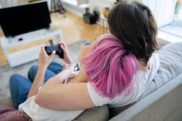 Free photo cute couple playing videogames