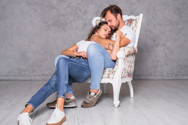 Cute couple sleeping in armchair