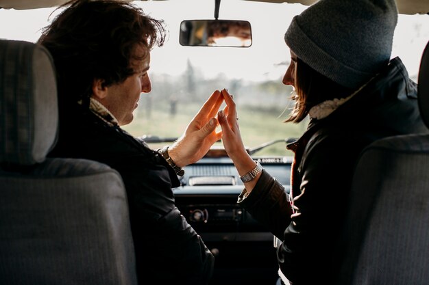 Cute couple touching their hands in a van