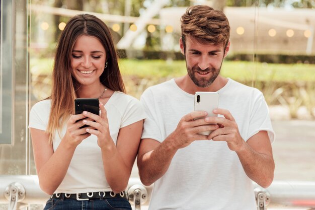 Cute couple with phones texting