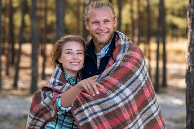 Cute couple wrapped in a blanket