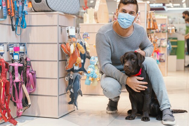 Cute dog with owner at the pet shop