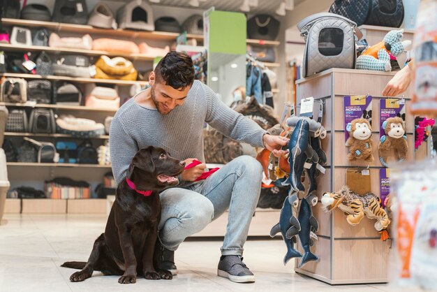 Cute dog with owner at the pet shop