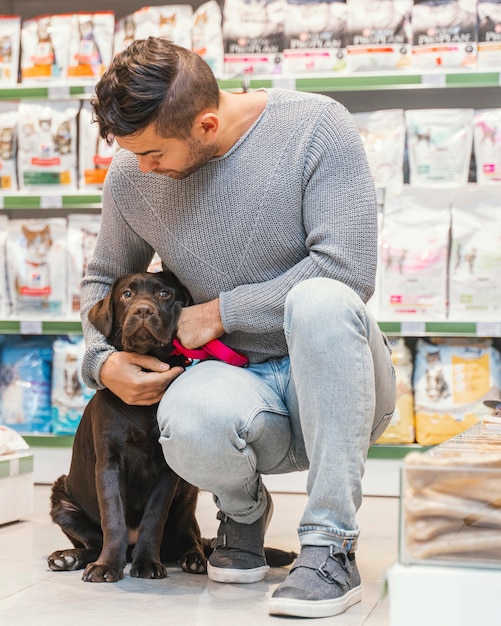 Free Photo cute dog with owner at the pet shop