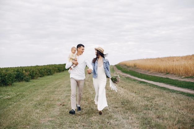 Cute family playing in an autumn field