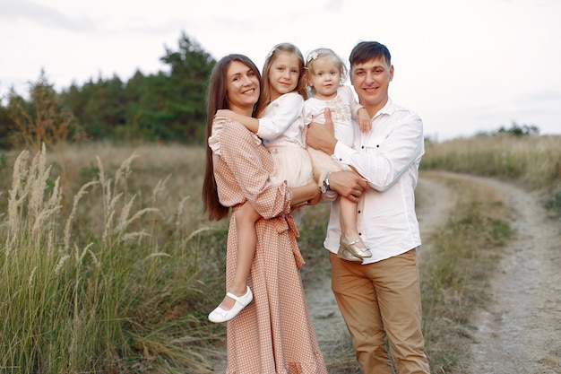 Cute family playing in a autumn field