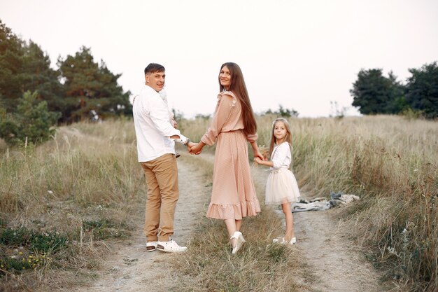 Cute family playing in a autumn field