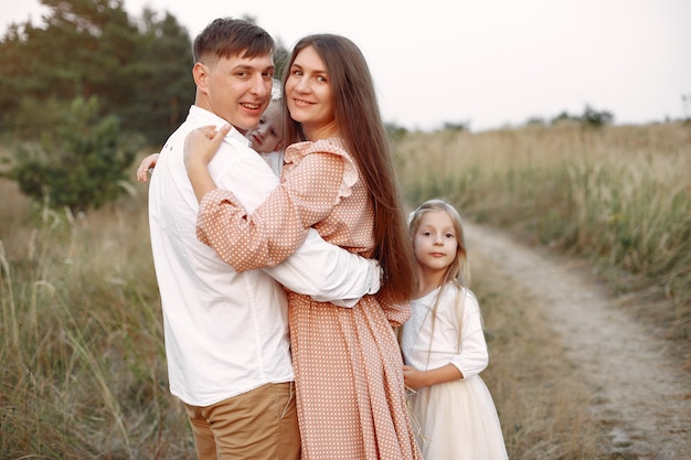 Cute family playing in a autumn field