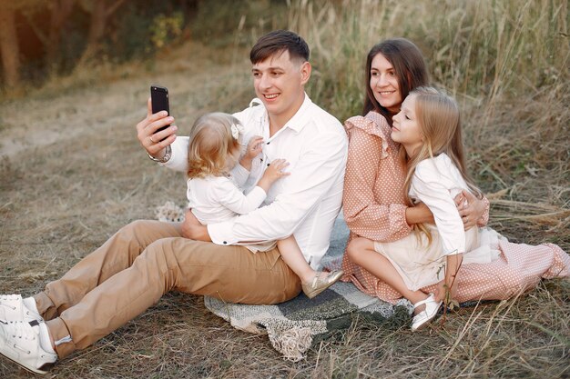 Cute family playing in a autumn field