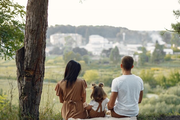 Cute family playing in a autumn field