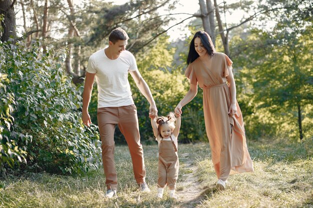 Cute family playing in a autumn field