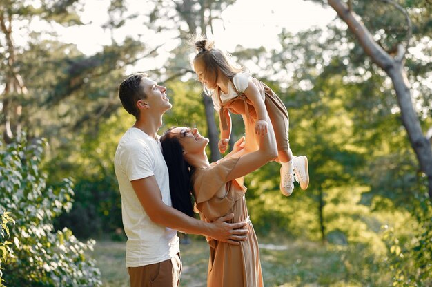 Cute family playing in a autumn field