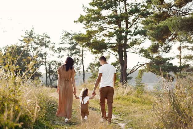 Cute family playing in a autumn field