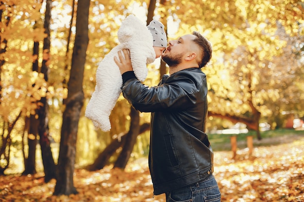 Cute family playing in a autumn park