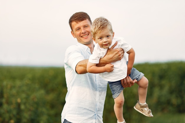 Cute family playing in a summe field