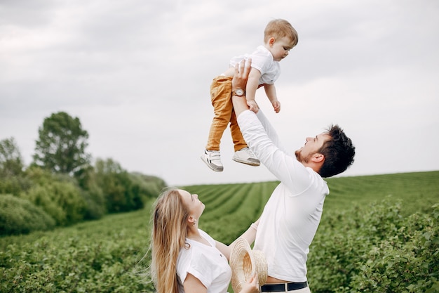 Free photo cute family playing in a summer field