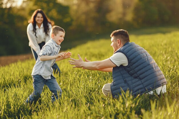 Cute family playing in a summer field