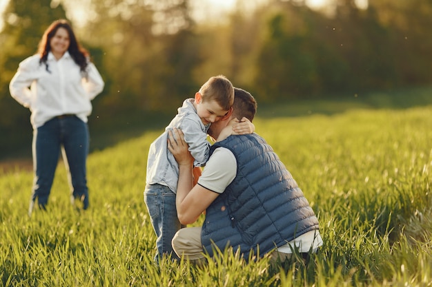 Free photo cute family playing in a summer field