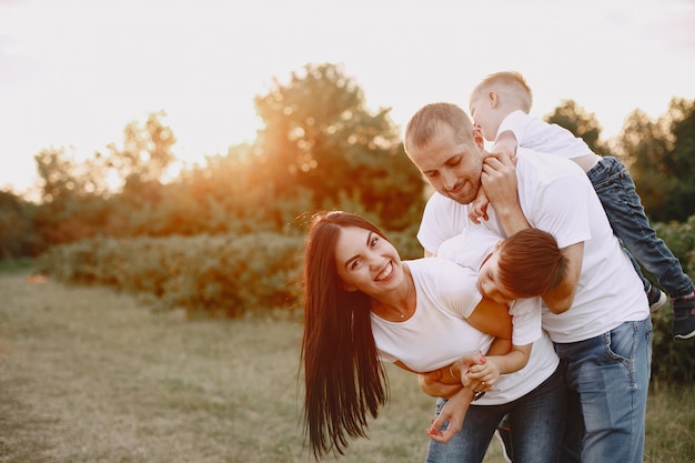 Free photo cute family playing in a summer field