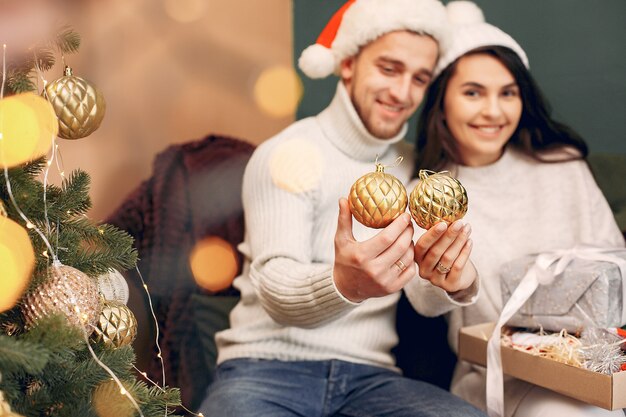 Cute family sitting at home near christmas tree