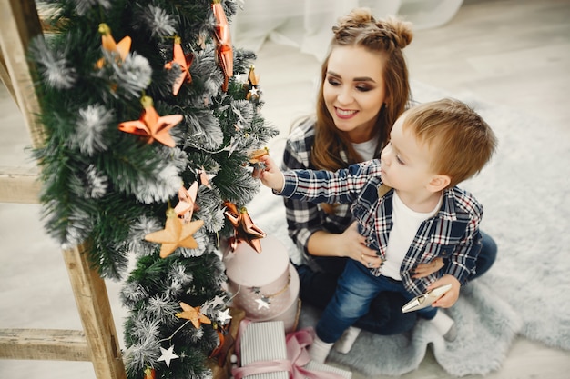 Cute family sitting near Christmas tree