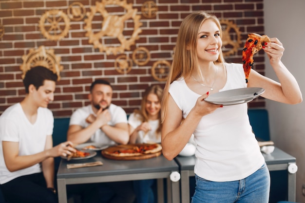 Cute friends in a cafe eatting a pizza