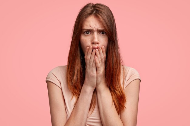 Cute ginger woman with pink T-shirt