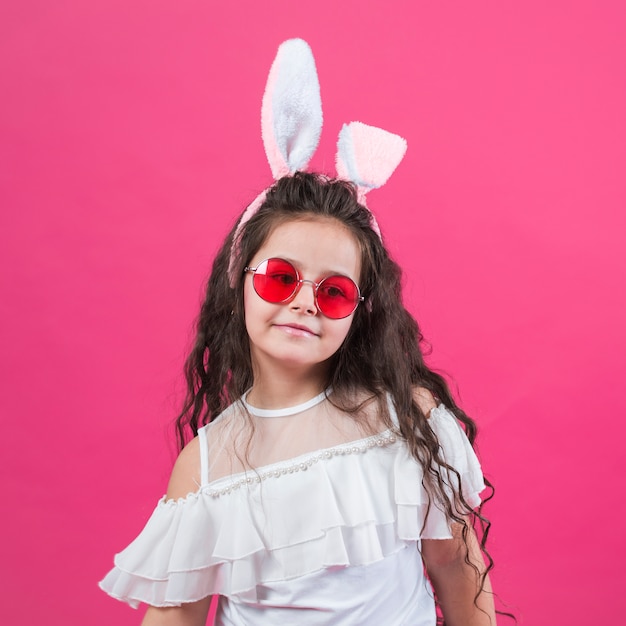 Free photo cute girl in bunny ears and sunglasses