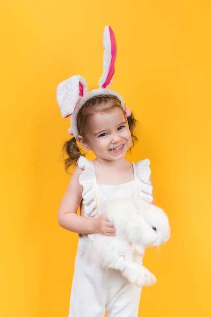 Free photo cute girl in bunny ears with rabbit