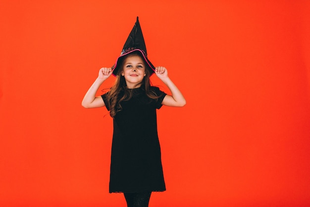 Cute girl dressed in halloween costume in studio