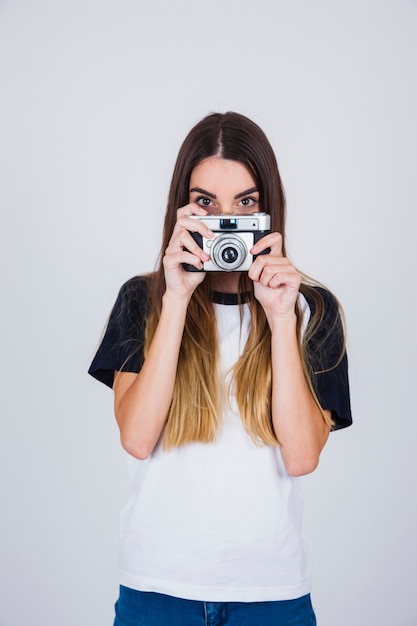 Cute girl hiding behind the camera