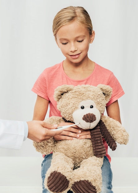 Cute girl holding teddy bear