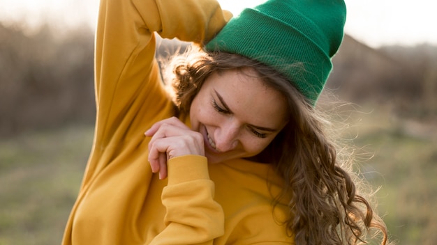 Free photo cute girl outdoors wearing a green hat