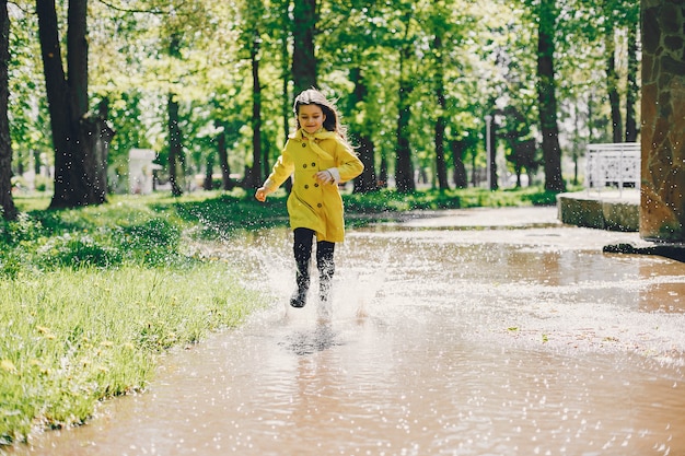 Cute girl plaiyng on a rainy day