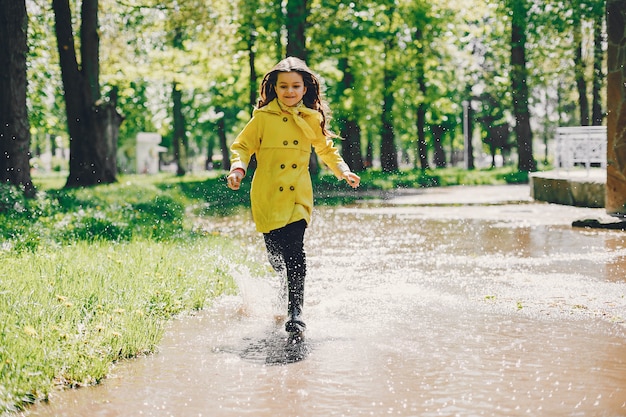 Free photo cute girl plaiyng on a rainy day