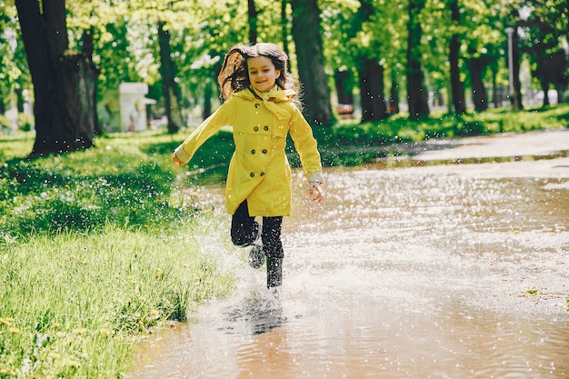 Free photo cute girl plaiyng on a rainy day