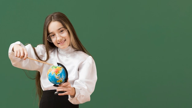 Cute girl pointing at globe