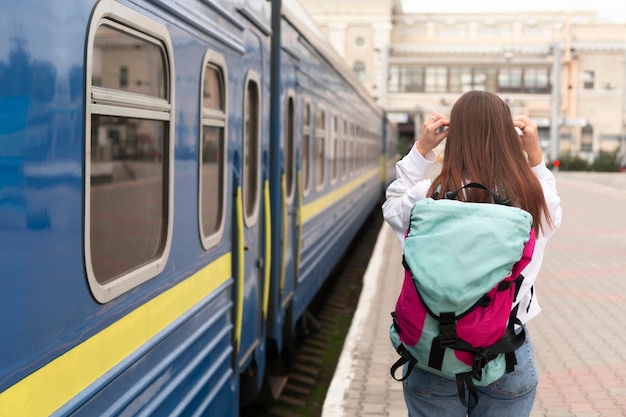 Cute girl at the railway station from behind shot