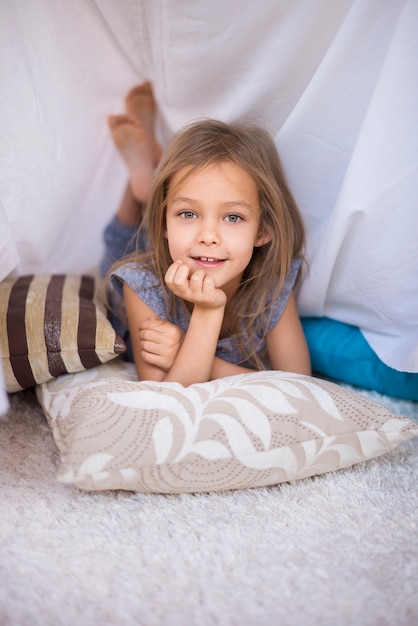 Free Photo cute girl resting in her hand made shelter