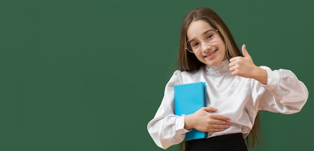 Cute girl showing thumbs up