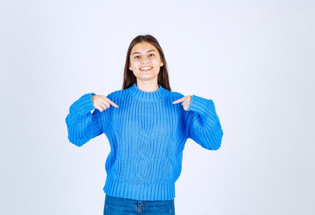 cute girl standing and pointing on white.