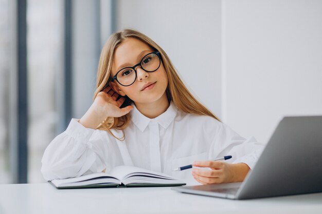 Cute girl studying on the computer at home