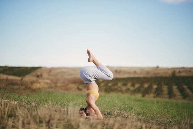 Free Photo cute girl training on blue sky in a field