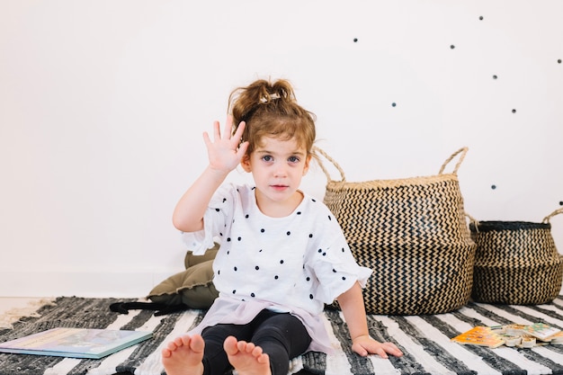 Free photo cute girl waving hand