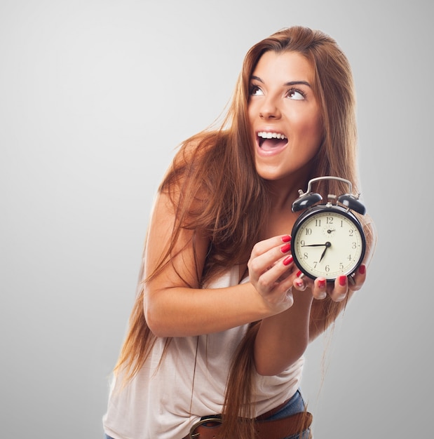 Free photo cute girl with alarm clock