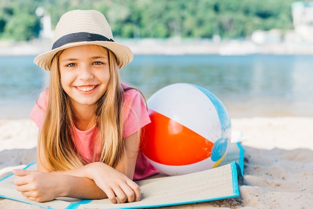 Free photo cute girl with ball smiling on coast