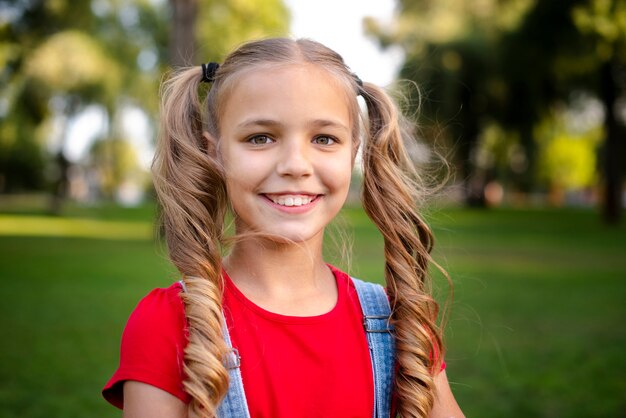 Cute girl with blond hair smiling at camera